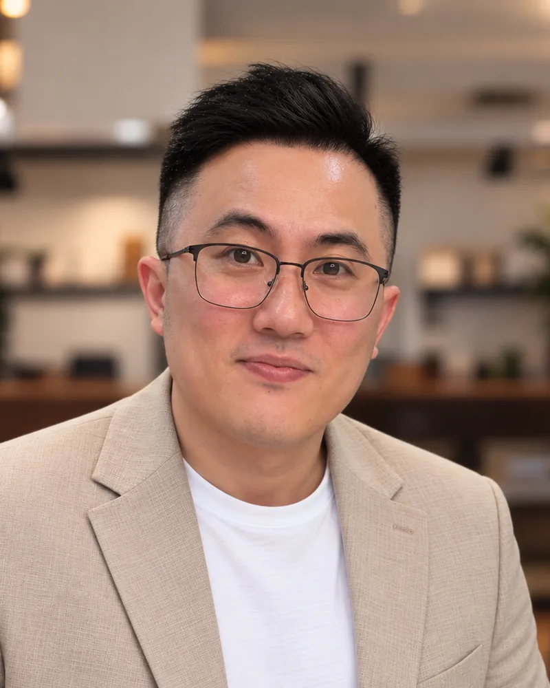 Karvin Ong, Technical Lead, smiling in a blazer and glasses